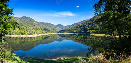 Clear lake with reflections and mountains in background in Vosges, France