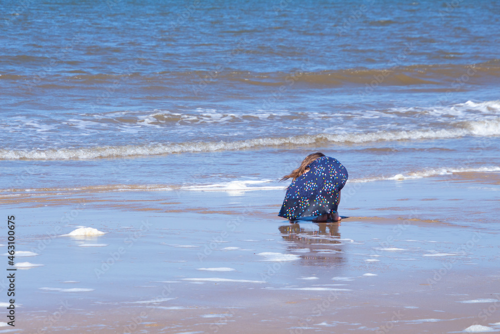 Obraz premium child playing on the beach, british beach, british, summer, british summer, norfolk beach