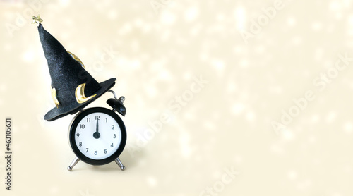 Фотография Clock in a magic hat on a light background