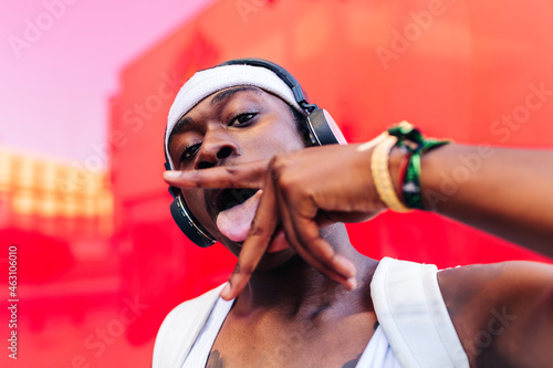 Black man with tongue between fingers photo