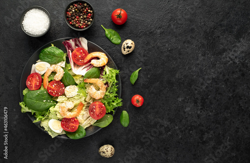 Fresh seafood salad. Grilled shrimp, fresh vegetable salad and egg. Fried shrimps. Healthy food on stone background with copy space for your text
