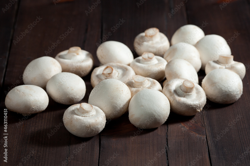 Mushrooms on a brown wooden background, close-up. Healthy vegan and vegetarian diet concept Mushrooms on a brown wooden background, close-up. Healthy vegan and vegetarian diet concept