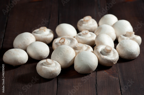 Mushrooms on a brown wooden background, close-up