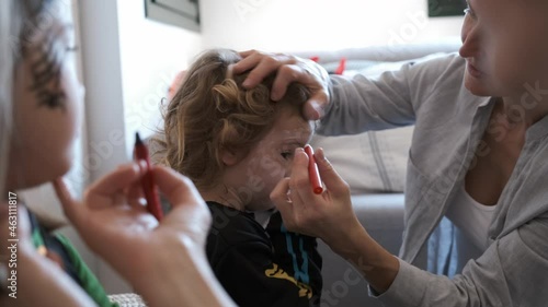 Family painting their children for halloween