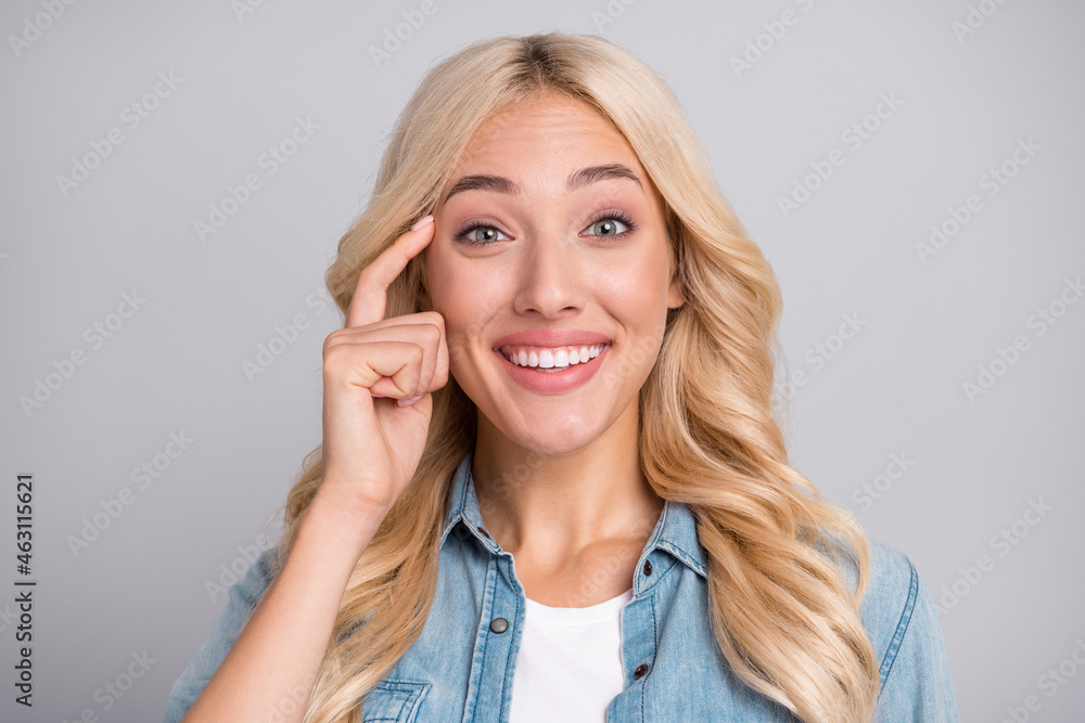 Photo of young girl happy positive smile finger touch head think forget memory remember isolated over grey color background Photo of young girl happy positive smile finger touch head think forget memory remember isolated over grey color background