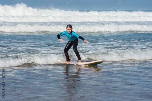 cute little girl taking a surf lesson