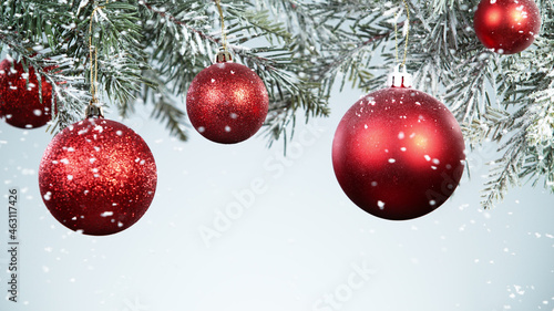 Christmas balls hanging on snowy fir tree