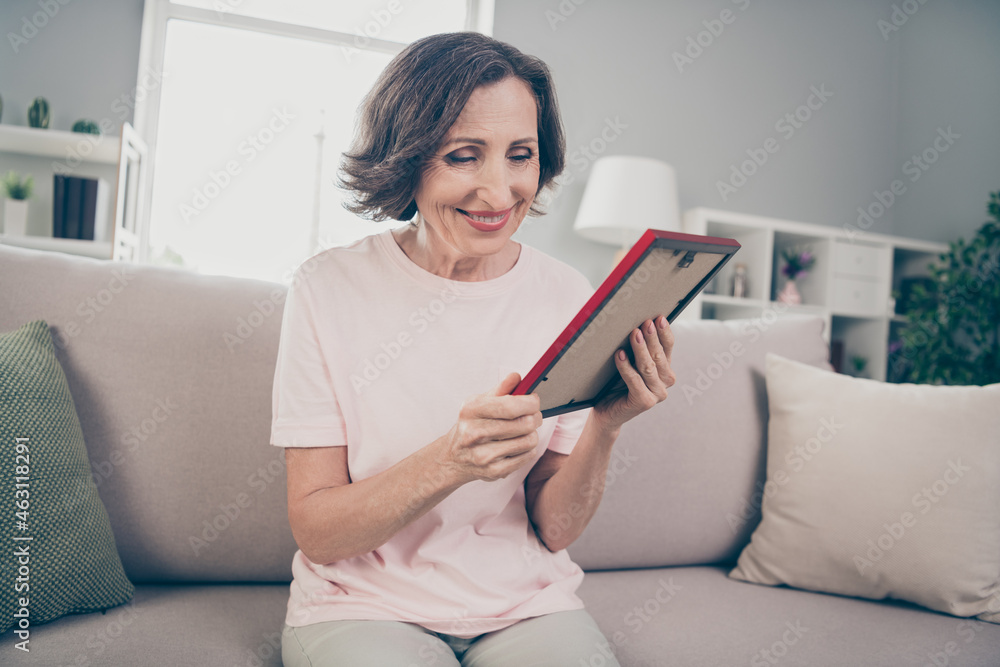 Photo of aged brunette nice lady look photo wear pink t-shirt trousers at home alone Photo of aged brunette nice lady look photo wear pink t-shirt trousers at home alone