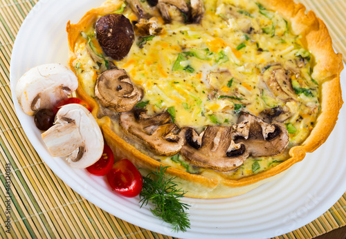 Mushroom pie filled with shiitake, porcini and champignons with Philadelphia cheese and Cheddar garnished with fresh tomatoes