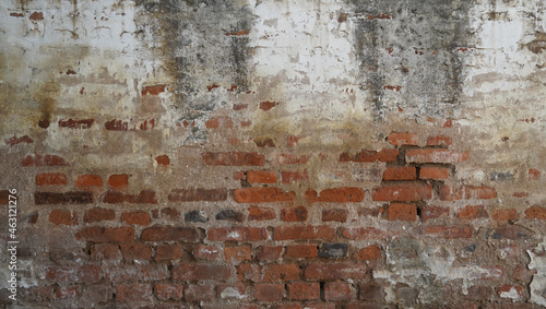 the worn and stained concrete brick wall. the obsolete wall for grunge background texture. aged texture for creative street design elements.
