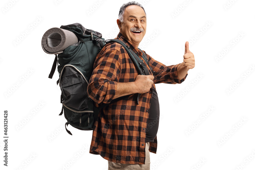 Smiling mature hiker with a backpack showing thumbs up Smiling mature hiker with a backpack showing thumbs up