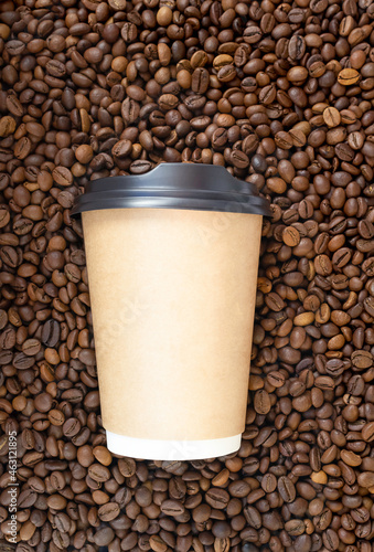 Paper cup on the background of coffee beans, background with natural coffee