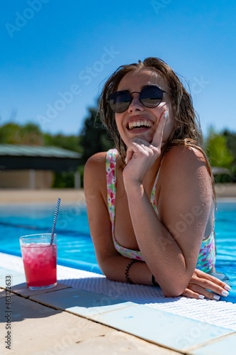 Obraz na płótnie young girl in the pool having a refreshing drink w salonie
