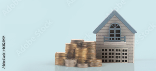 Model of detached miniature house mock and coins