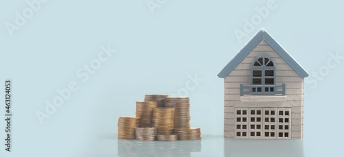 Model of detached miniature house mock and coins