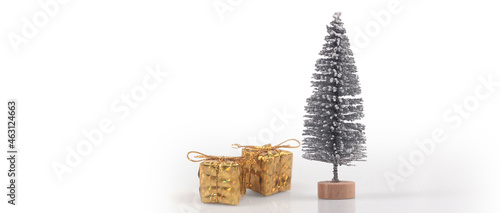 Decorated Christmas tree hanging on pine branches and gift boxes © denphumi