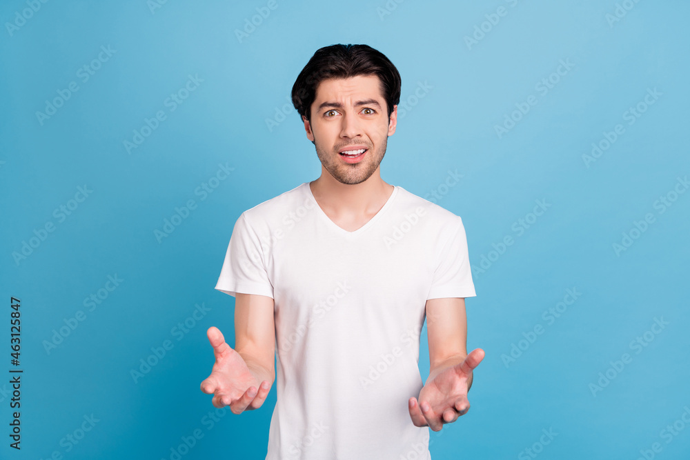 Photo of frustrated disappointed man open mouth stretch hands wear white t-shirt isolated blue color background - obrazy, fototapety, plakaty 