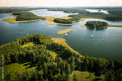 Fototapeta Naklejka Na Ścianę i Meble -  Aerial view of green islands and clouds at summer sunny day. Masurian Lake District in Poland. 