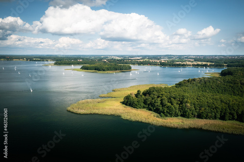 Aerial view of green islands and clouds at summer sunny day. Masurian Lake District in Poland. 