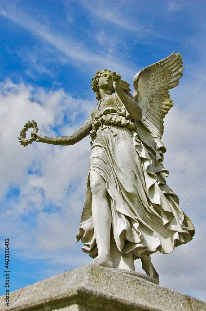 Statue of angel against the blue sky in Enniskerry, Ireland Statue of angel against the blue sky in Enniskerry, Ireland