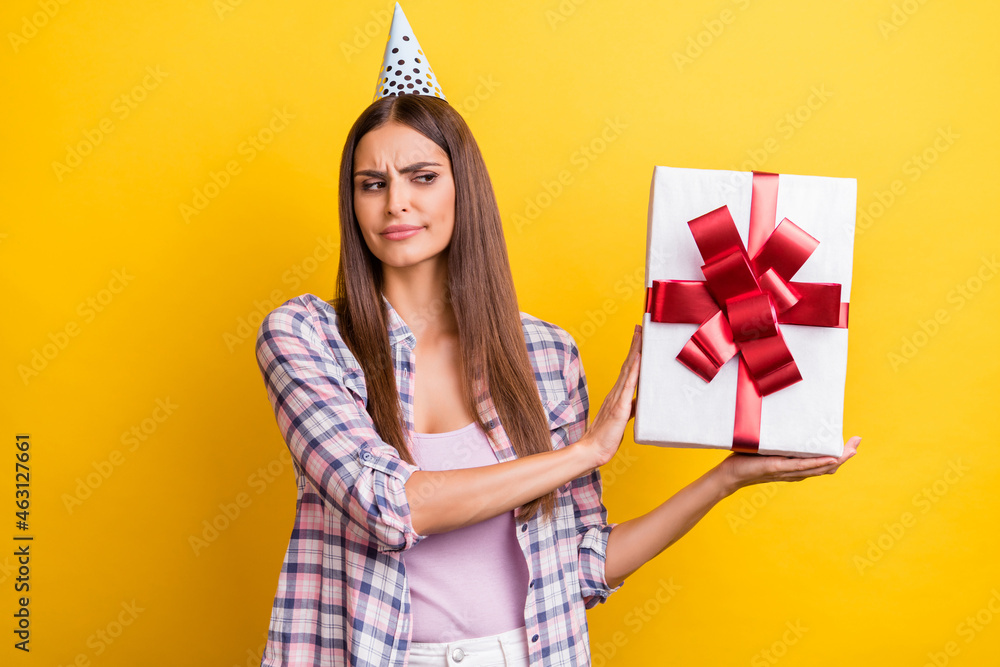 Photo of young woman unhappy sad dislike refuse present box surprise birthday isolated over yellow color background - obrazy, fototapety, plakaty 