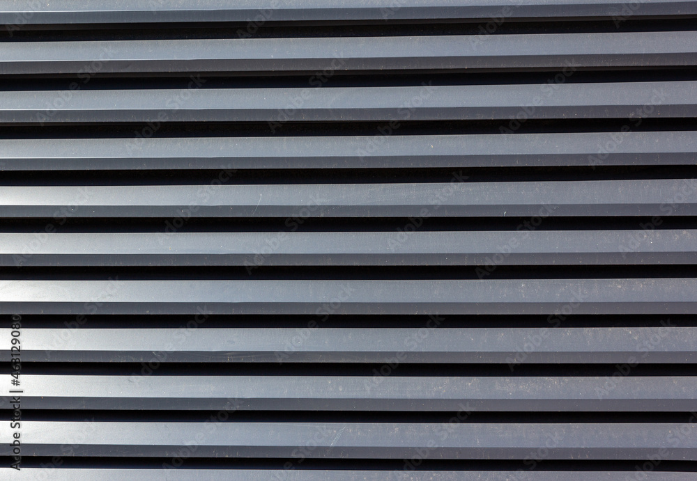 Corrugated sheet metal, badly painted with gray paint for background. Metal corrugated roofing sheet.Painting of metal surfaces for rust control Abstract background for sites and layouts. Iron fence Corrugated sheet metal, badly painted with gray paint for background. Metal corrugated roofing sheet.Painting of metal surfaces for rust control Abstract background for sites and layouts. Iron fence
