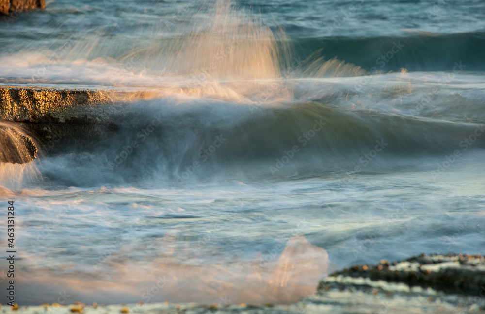 Stormy windy sea waves splashing on a rocky seashore