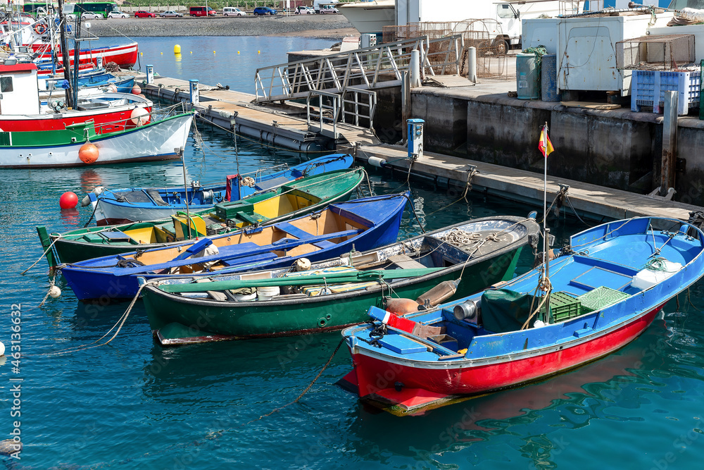 Las Galletas port with fishing boats with the Teide mountain in the background. In Tenerife. Canary Islands.