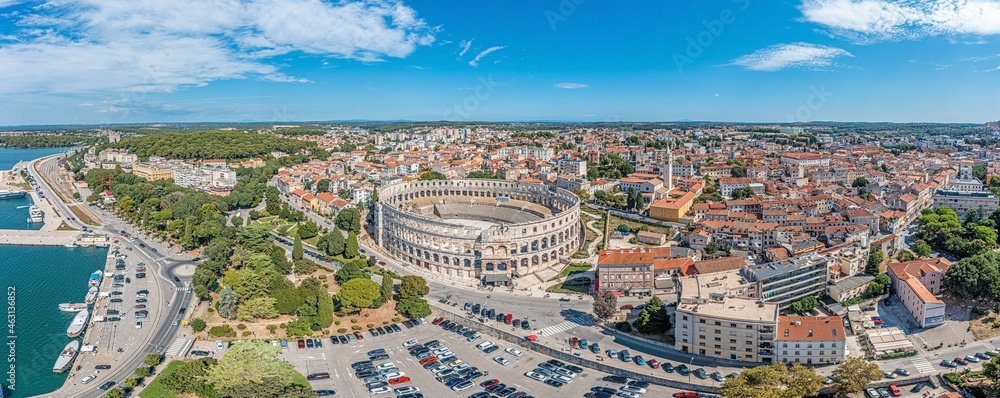 Drone panorama of the Croatian coastal city of Pula taken during the day above the harbor