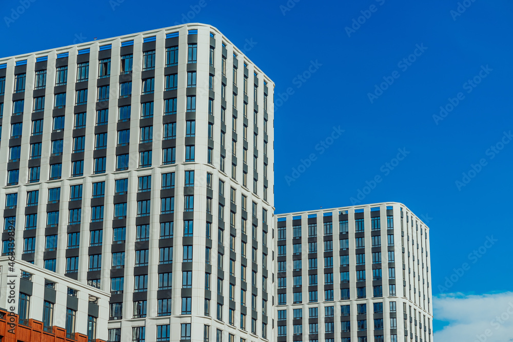 Fototapeta premium Windows of the residential building. Urban obsolete facade of house. The windows of building 