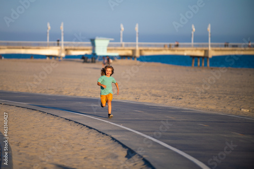 Cute boy running. Child boy run outdoor.