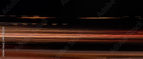 Abstract defocused light trails on the dark background, motion blur