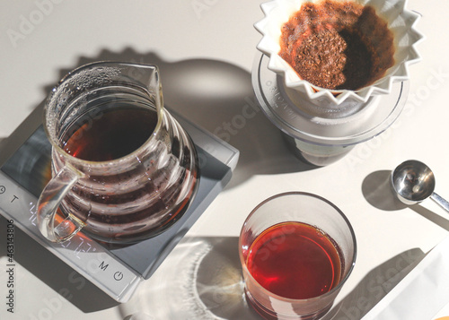 Filter coffee in a carafe with cup and brewer