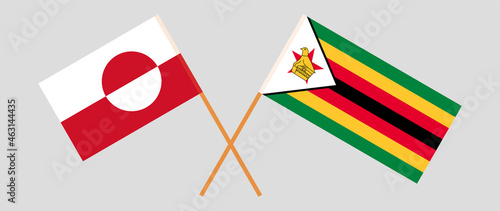 Crossed flags of Greenland and Zimbabwe. Official colors. Correct proportion photo