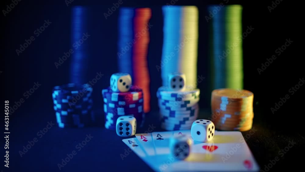 Casino chips with dice and playing cards on a dark table. Concept of gambling or poker and entertainment. Close up macro shoot. Online casino betting Casino chips with dice and playing cards on a dark table. Concept of gambling or poker and entertainment. Close up macro shoot. Online casino betting