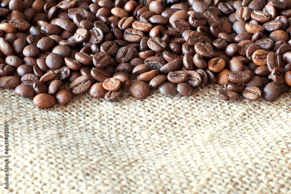 Close-up coffee beans lying on burlap Close-up coffee beans lying on burlap