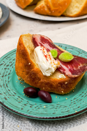 A slice of bread with Bulgarian salami, cheese and chutney photo