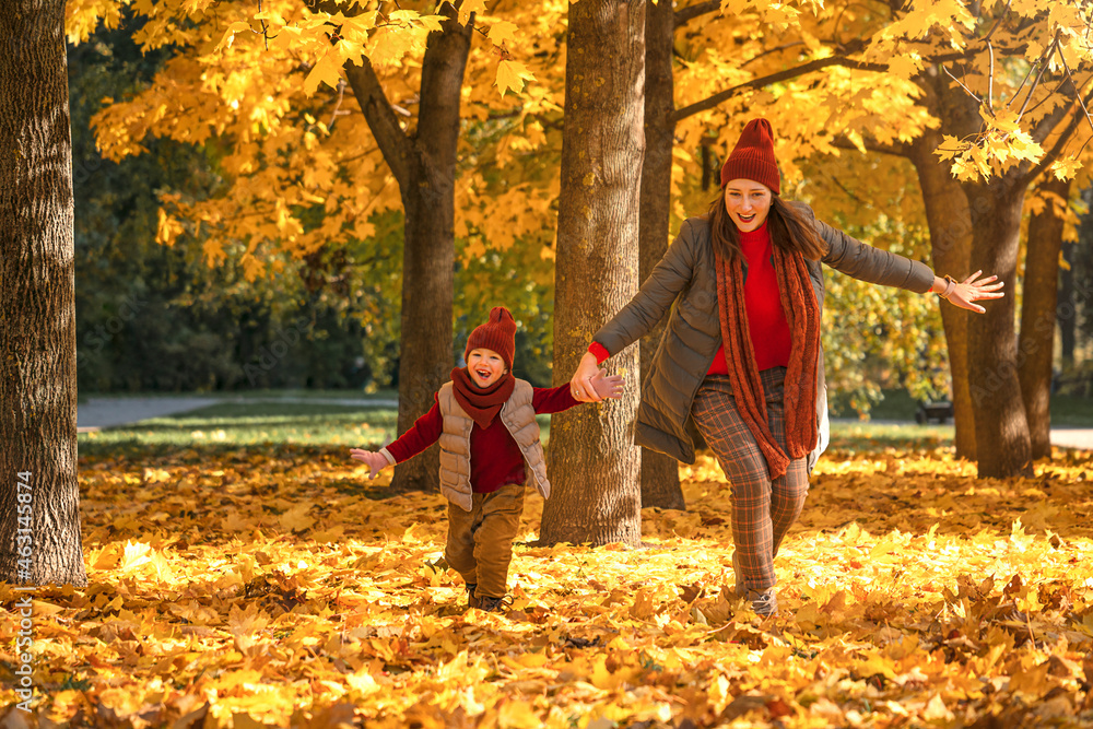 Happy mother and daughter play on autumn park Happy mother and daughter play on autumn park