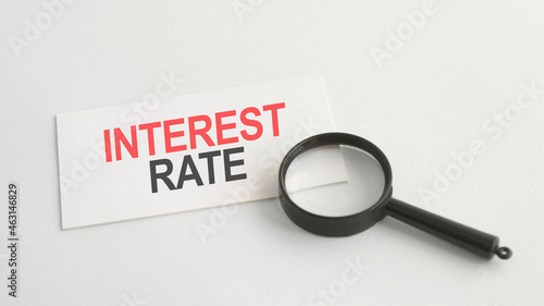 Text interest rate on the white paper card, on lens background