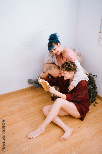 Lesbian couple dressed in a yellow outfit are comfortable at home
