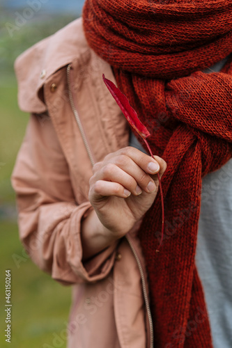 Woman in red scarf holding red twig photo