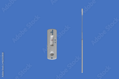 Negative Corona Covid 19 rapid self test cassette and nasal swab with blue background