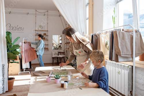 Mother and son painting in eco store photo