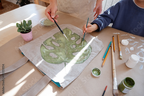 Mother and son painting leaf photo