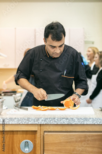 Class: Chef Prepares Orange For Dish photo