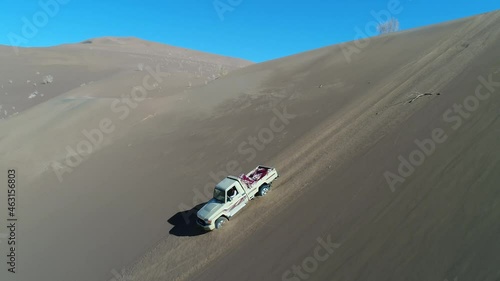 zahedan, baluchestan/iran-11/24/2019 truck shot from a Toyota Land Cruiser 79 Namib edition climbing down a sand dune in the desert photo