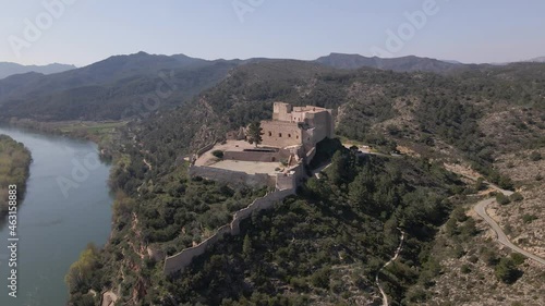 Drone shot of Miravet, Spain. Small town with medieval castel next to river. photo
