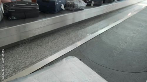 Moving luggage in the airport. Close up shot of various suitcase moving in the conveyor belt of terminal airport of Tirana.