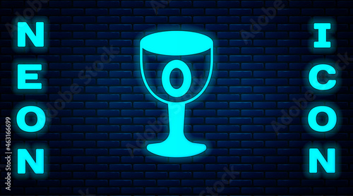 Glowing neon Medieval goblet icon isolated on brick wall background. Holy grail. Vector