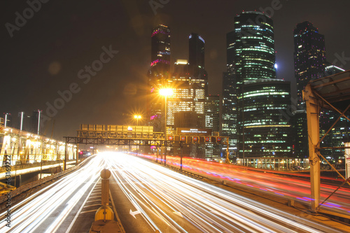tracers of traffic on highway in the downtown at night